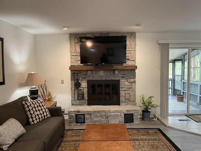 living room featuring hardwood / wood-style flooring and a fireplace