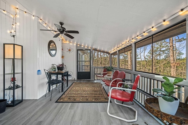 sunroom / solarium featuring ceiling fan