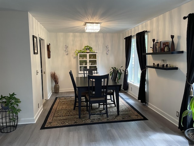 dining space featuring a notable chandelier and dark hardwood / wood-style flooring