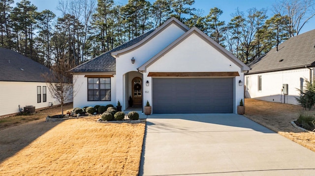 view of front of home featuring a front yard, a garage, and central AC unit