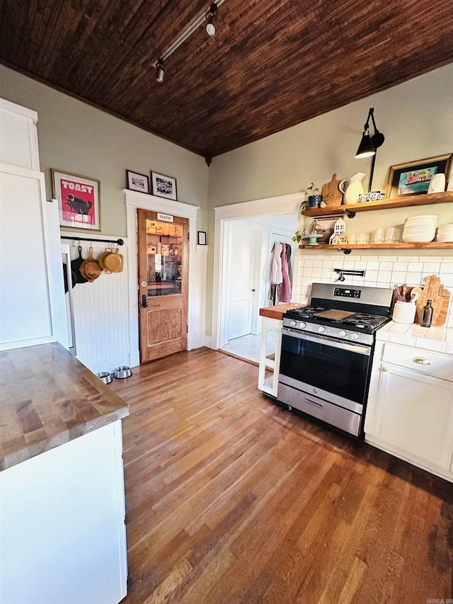 kitchen featuring hardwood / wood-style floors, tasteful backsplash, wood ceiling, white cabinetry, and stainless steel gas stove