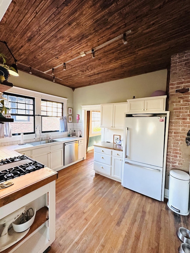 kitchen featuring wood ceiling, white cabinetry, white fridge, and stainless steel dishwasher