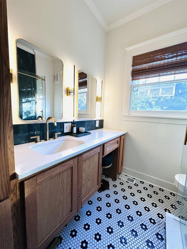 bathroom featuring crown molding, tile patterned flooring, walk in shower, and vanity