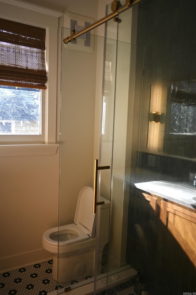 bathroom with toilet, tile patterned flooring, walk in shower, and vanity