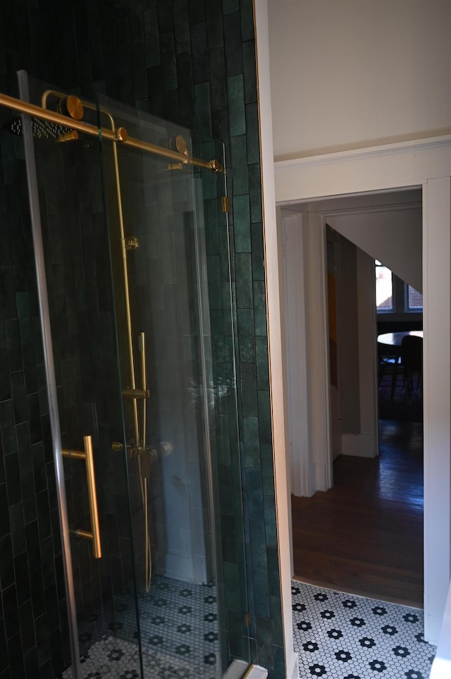 bathroom featuring a shower with shower door and tile patterned floors