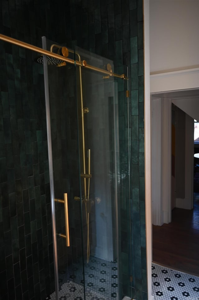 bathroom with walk in shower and tile patterned flooring