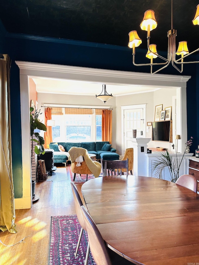 dining room with an inviting chandelier and wood-type flooring