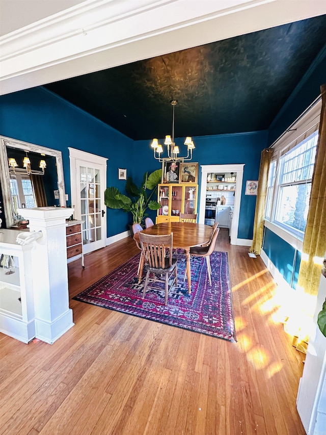 dining area featuring an inviting chandelier and light hardwood / wood-style flooring