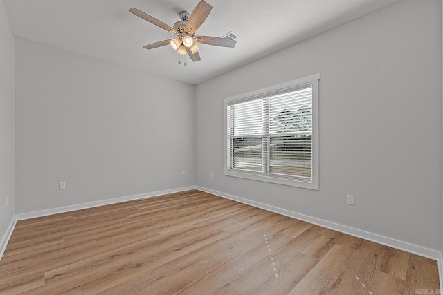 empty room featuring ceiling fan and light hardwood / wood-style floors