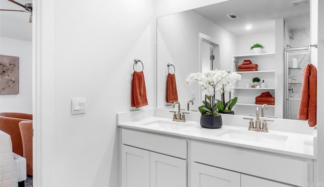 bathroom featuring vanity, walk in shower, and ceiling fan