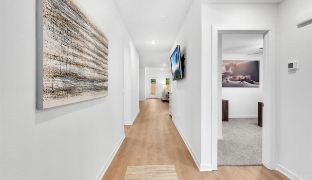 hallway with light hardwood / wood-style flooring