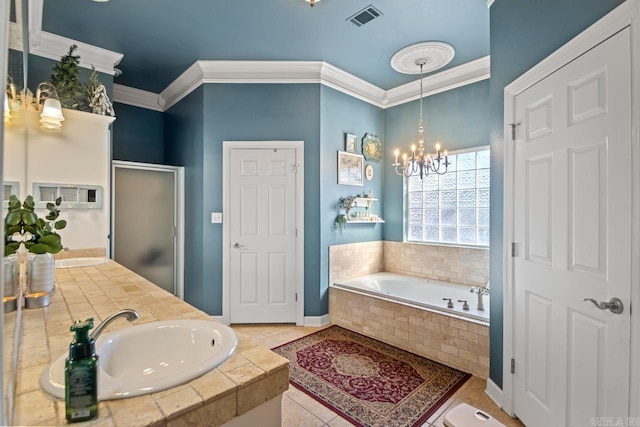 bathroom featuring tile patterned floors, vanity, crown molding, an inviting chandelier, and tiled bath