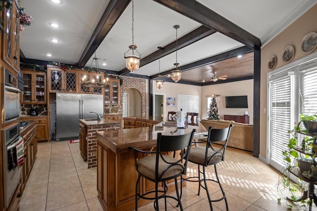 kitchen featuring a large island, ceiling fan, hanging light fixtures, and appliances with stainless steel finishes