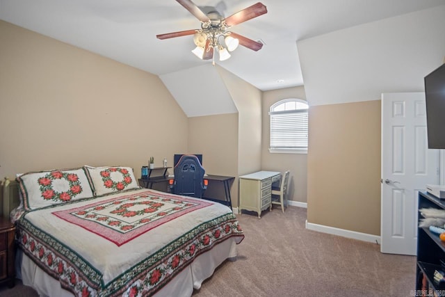 carpeted bedroom with ceiling fan and vaulted ceiling