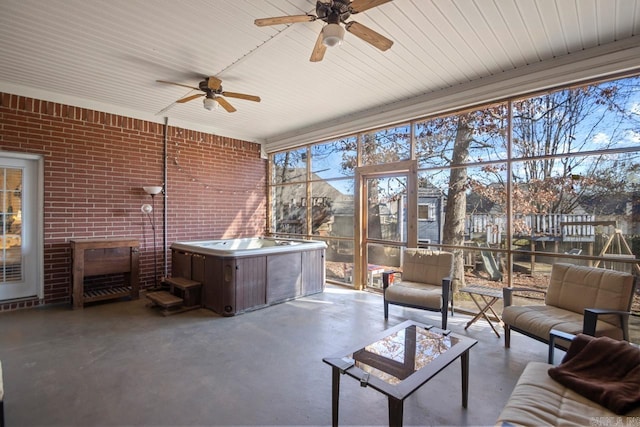 unfurnished sunroom featuring ceiling fan and a wealth of natural light