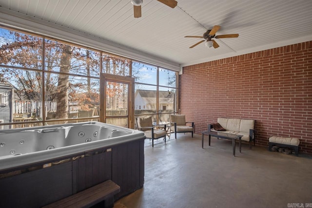 unfurnished sunroom featuring ceiling fan