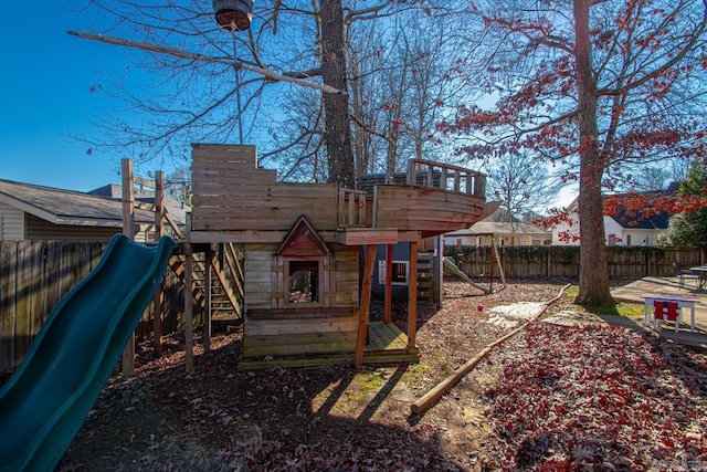 back of property featuring a playground