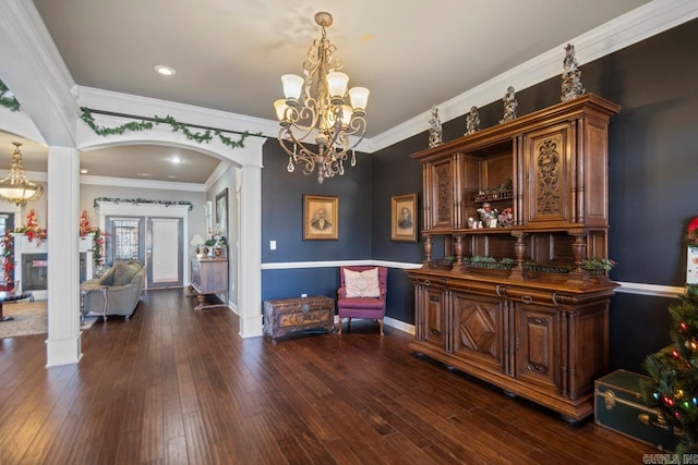 bar featuring a notable chandelier, pendant lighting, dark hardwood / wood-style floors, and ornamental molding