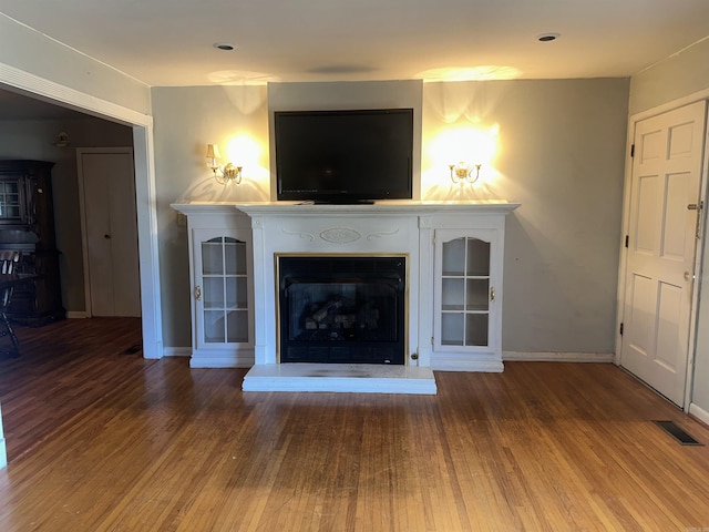 unfurnished living room featuring hardwood / wood-style flooring