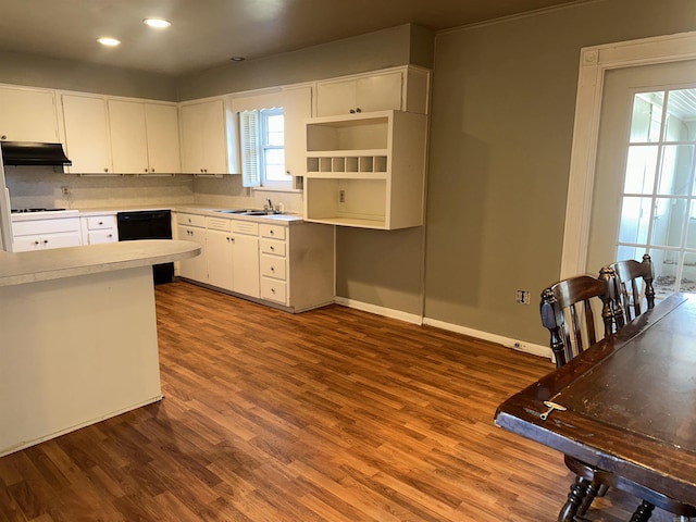 kitchen featuring dishwasher, white cabinets, sink, dark hardwood / wood-style floors, and stovetop