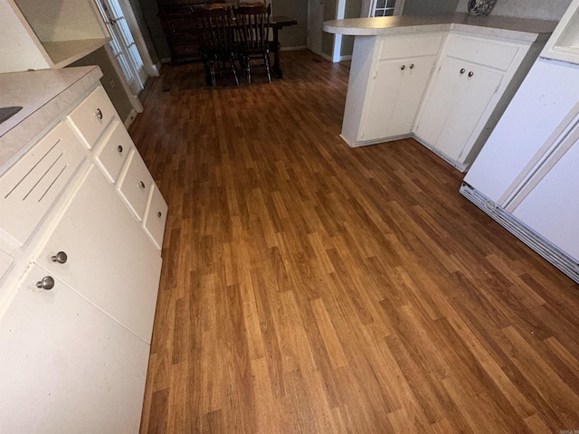 kitchen with white cabinets and dark wood-type flooring