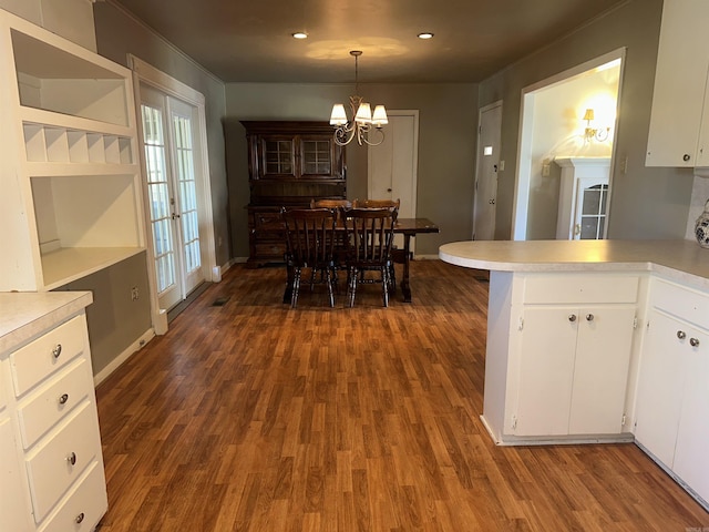 dining space featuring a notable chandelier and dark hardwood / wood-style floors