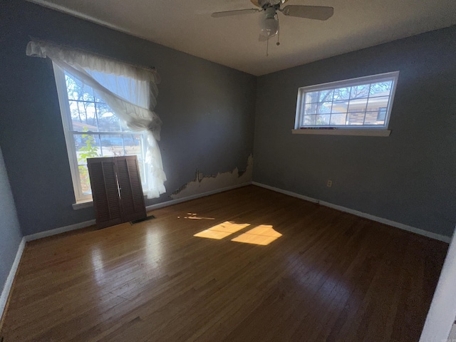 spare room with hardwood / wood-style flooring and ceiling fan