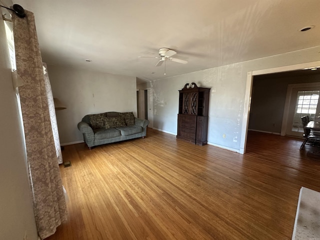 unfurnished living room with hardwood / wood-style floors and ceiling fan