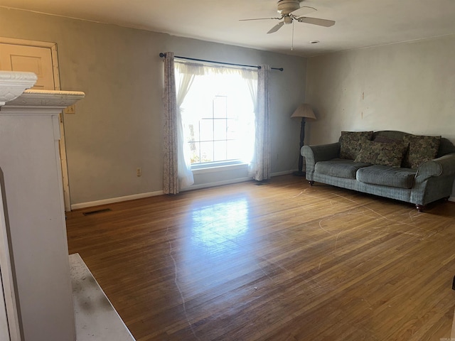 living room with wood-type flooring and ceiling fan