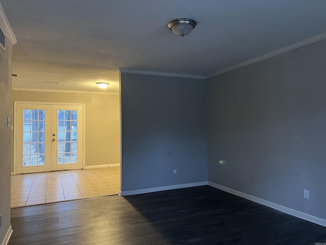 unfurnished room featuring french doors, crown molding, and wood-type flooring