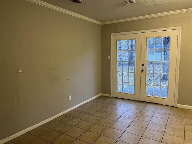 entryway with french doors, a textured ceiling, light tile patterned floors, and ornamental molding