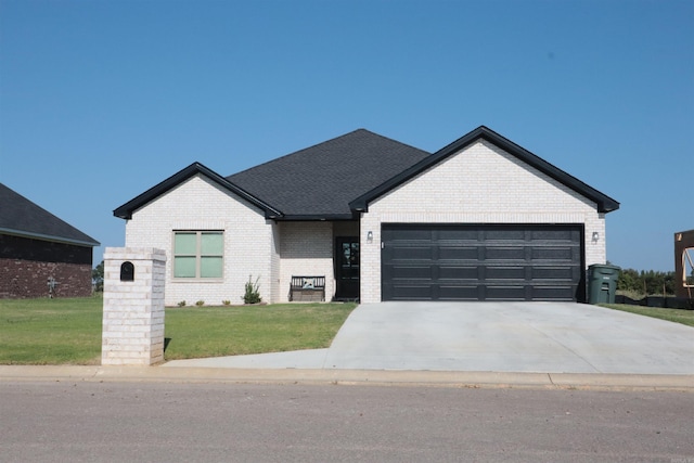 view of front facade with a front yard and a garage