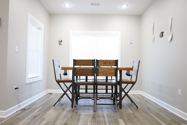 dining space with light hardwood / wood-style flooring