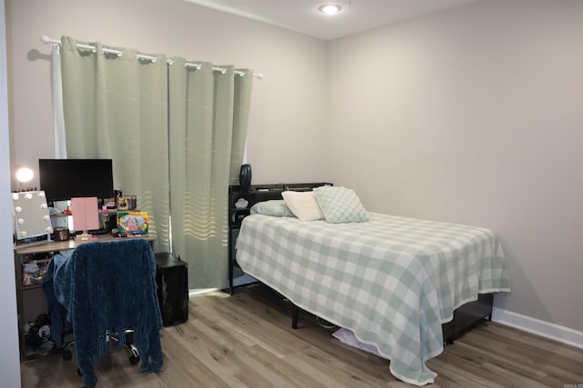 bedroom with hardwood / wood-style flooring