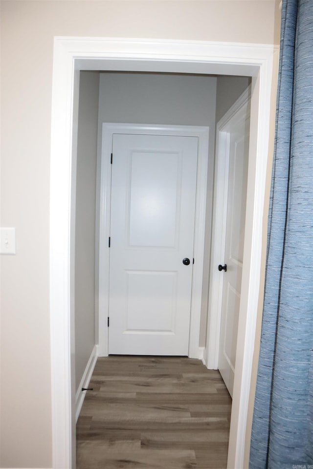 hall with dark wood-type flooring