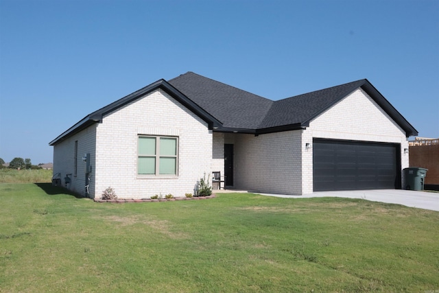 view of front of home with a front lawn and a garage