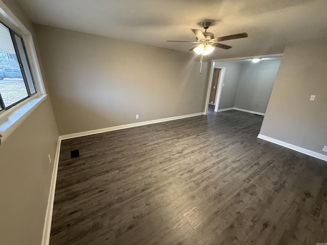 spare room with dark hardwood / wood-style floors and ceiling fan