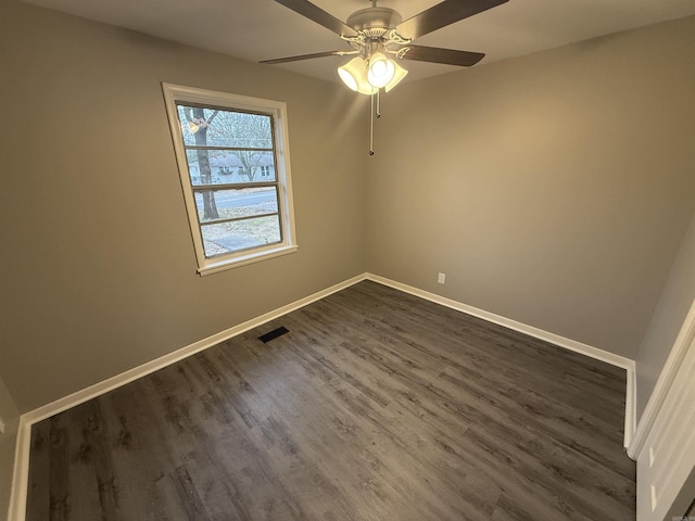 spare room featuring ceiling fan and dark wood-type flooring