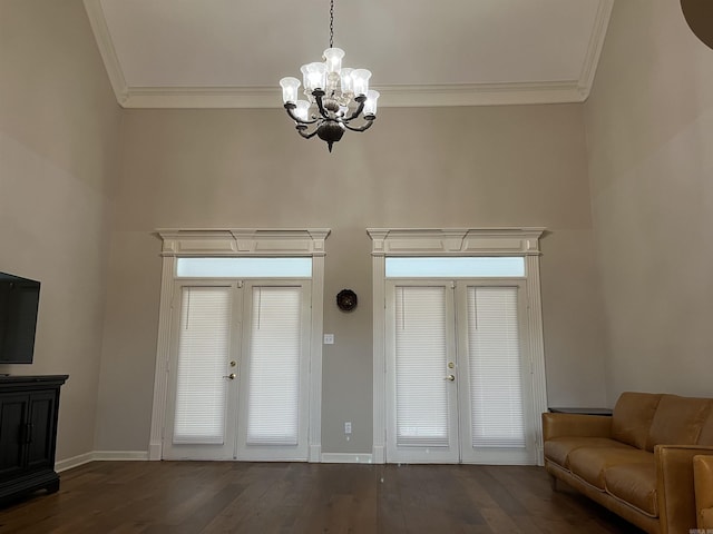 interior space with a chandelier, french doors, dark hardwood / wood-style flooring, and crown molding