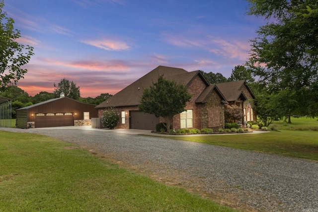 view of front of house with a yard, a garage, and an outdoor structure