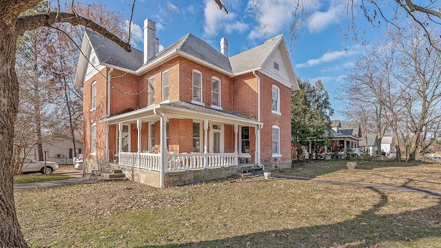 view of front of property with covered porch and a front lawn