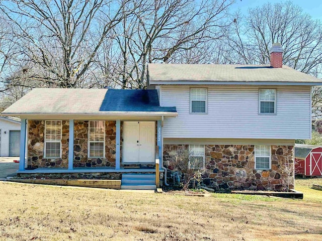 split level home with covered porch and a front yard