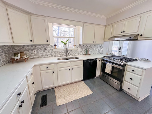 kitchen with black dishwasher, backsplash, stainless steel gas stove, and sink