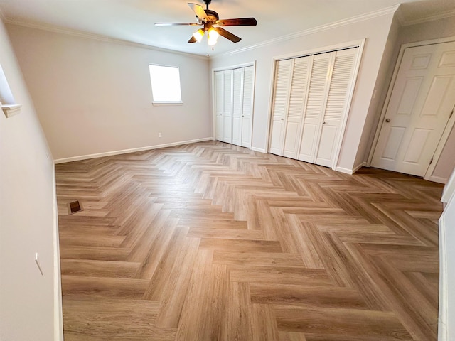 unfurnished bedroom with multiple closets, ceiling fan, light parquet floors, and ornamental molding