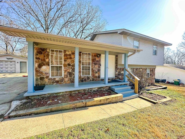 view of front of house with a porch, a garage, and an outdoor structure