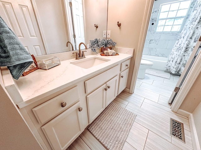 full bathroom featuring vanity, toilet, and shower / tub combo