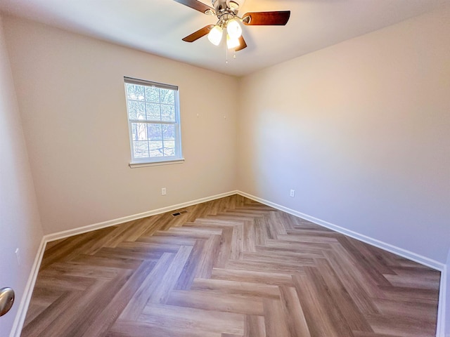 empty room featuring ceiling fan and light parquet flooring