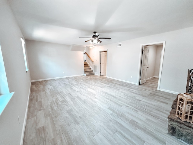 unfurnished living room featuring light wood-type flooring and ceiling fan