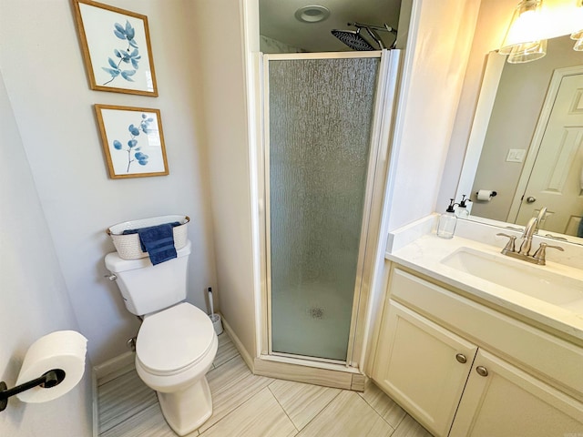 bathroom with a shower with door, vanity, and toilet