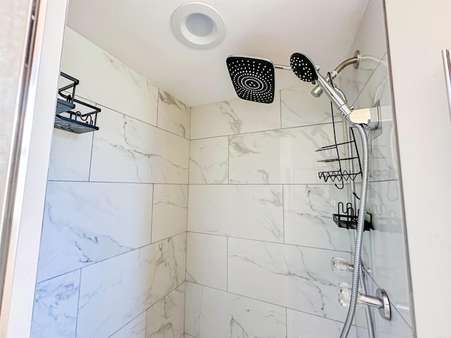 bathroom with a tile shower